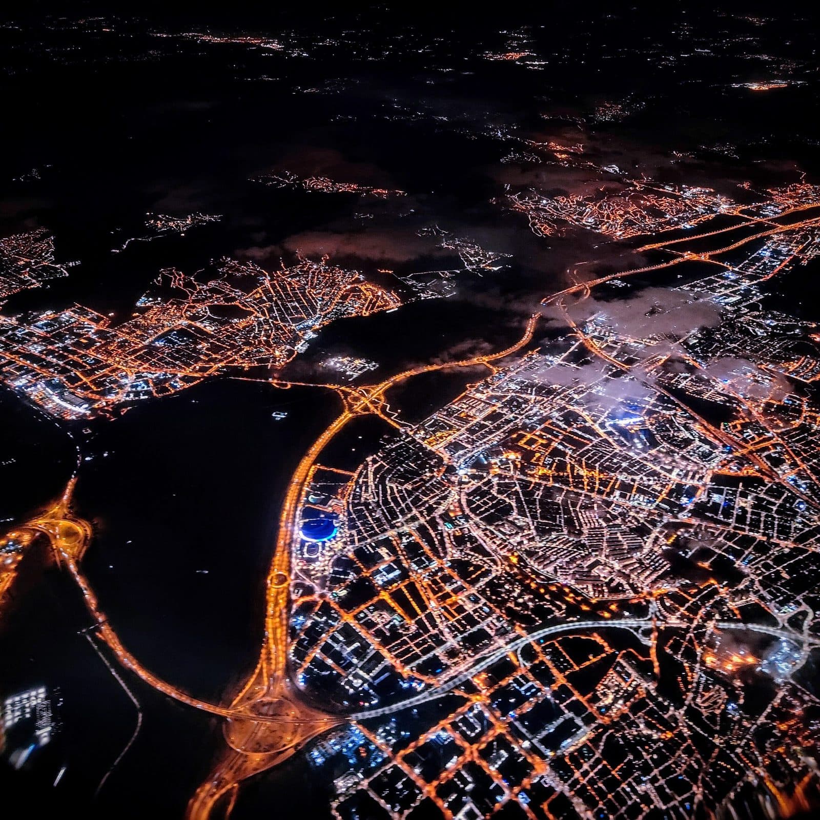 A city at night seen from a plane window