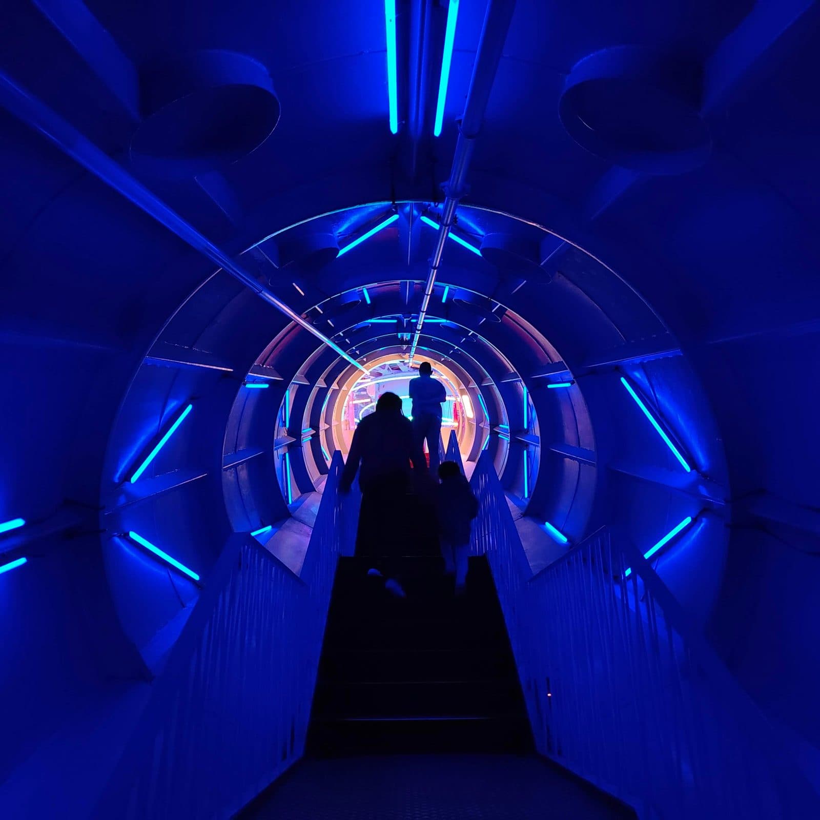 Stairs inside one of the Atomium tubes, lit in blue